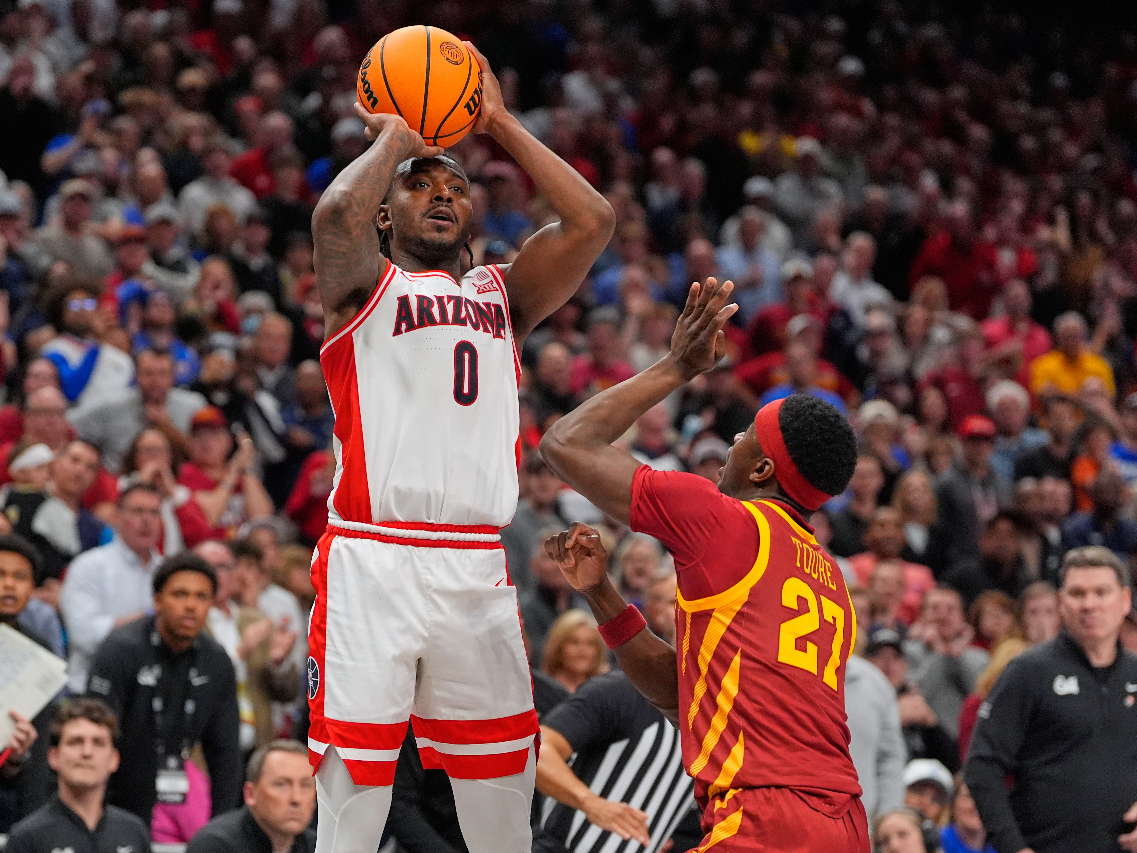 Arizona's Jaden Bradley (0) makes a game-winning basket over Iowa State's Killyan Toure at the buzzer to defeat Iowa State during an NCAA college basketball game in the semifinal round of the Big 12 Conference tournament Friday, March 13, 2026, in Kansas City, Mo.