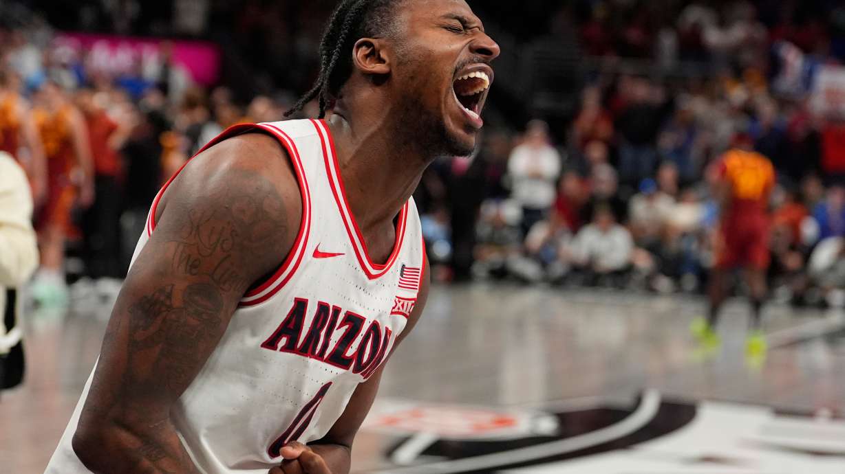 Arizona's Jaden Bradley celebrates after making the game-winning shot at the buzzer to defeat Iowa State during an NCAA college basketball game in the semifinal round of the Big 12 Conference tournament Friday, March 13, 2026, in Kansas City, Mo.