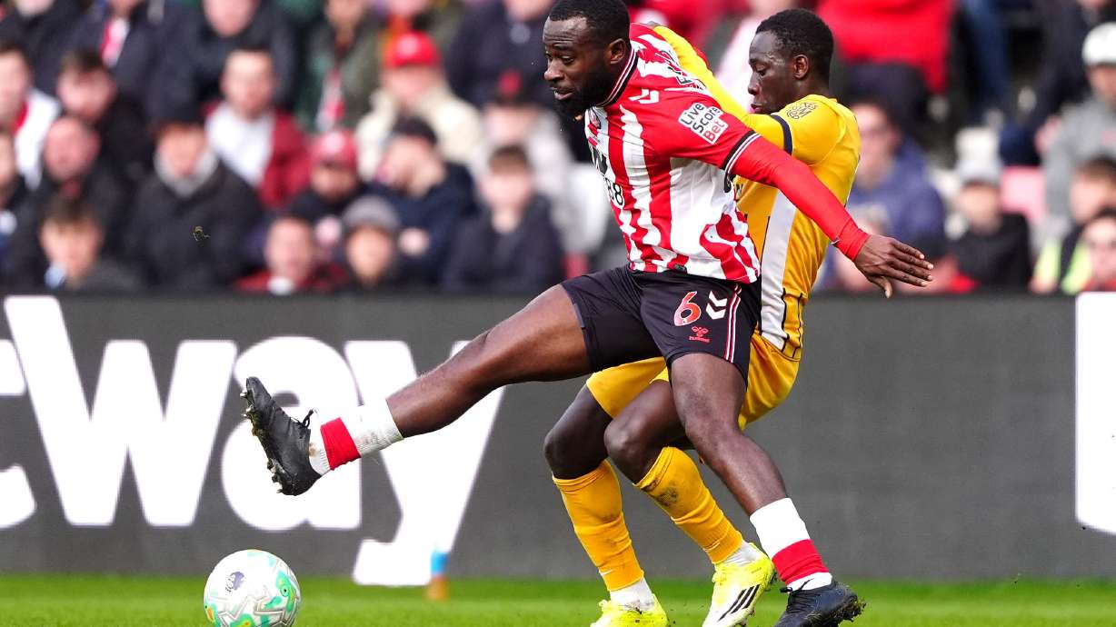 Sunderland's Lutsharel Geertruida, left, and Brighton and Hove Albion's Yankuba Minteh fight for the ball during the Premier League match in Sunderland, England, Saturday March 14, 2026.