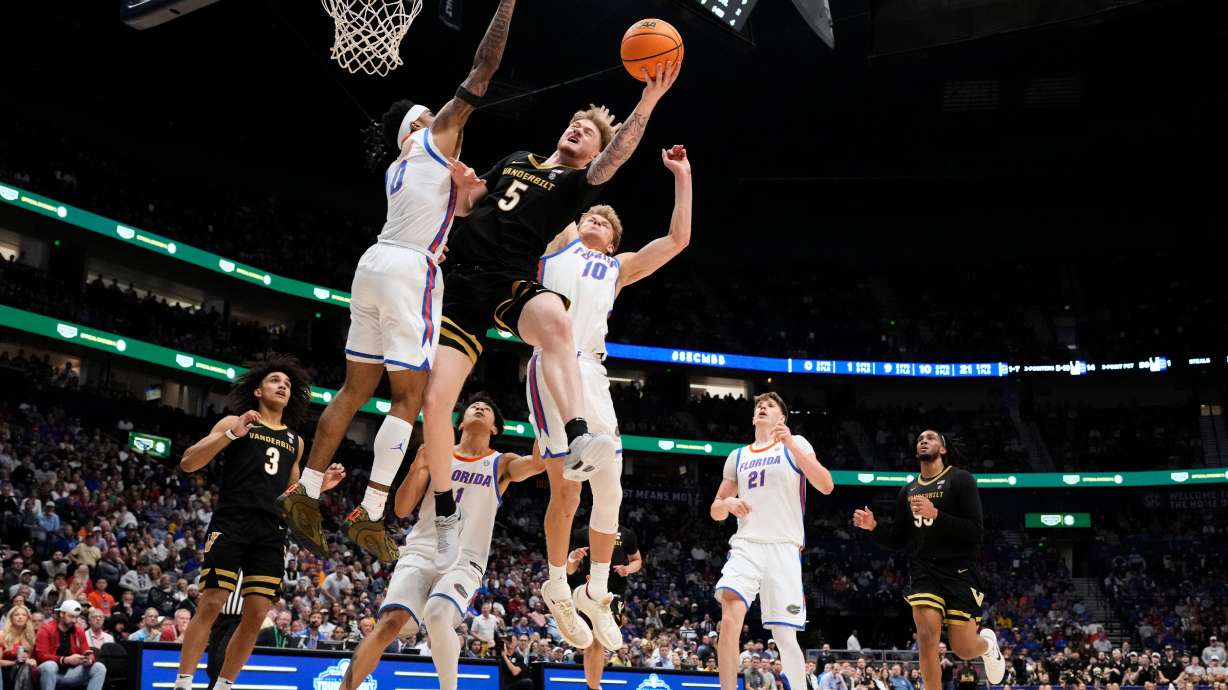 Vanderbilt forward Tyler Nickel (5) shoots the ball past Florida guard Boogie Fland (0) and forward Thomas Haugh (10) during the first half of an NCAA college basketball game in the semifinals of the Southeastern Conference tournament Saturday, March 14, 2026, in Nashville, Tenn.