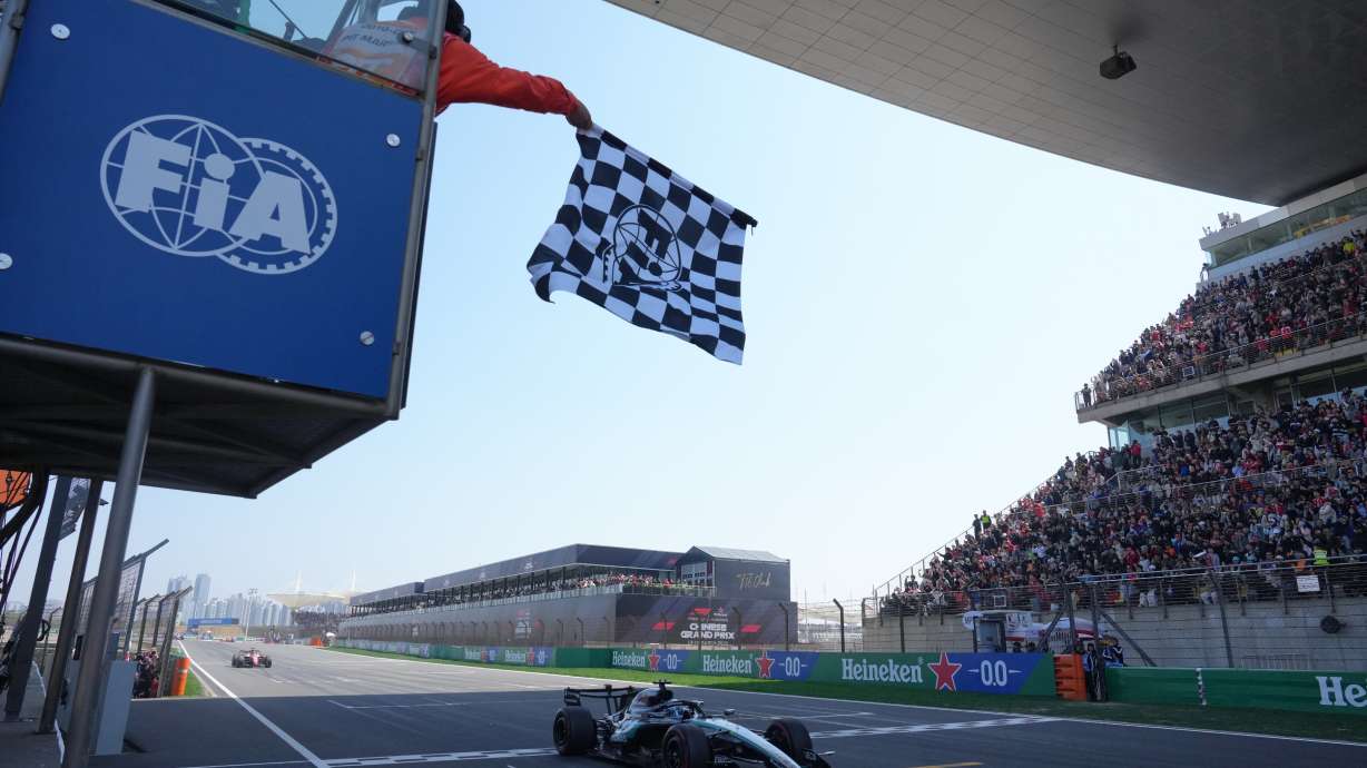 Mercedes driver George Russell of Britain crosses the finish line and wins the Sprint Race of the Chinese Formula One Grand Prix at the Shanghai International Circuit, in Shanghai, China, Saturday, March 14, 2026.