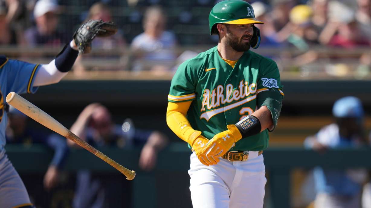 Athletics' Shea Langeliers flips his bat away after earning a walk against the Milwaukee Brewers during the third inning of a spring training baseball game Tuesday, Feb. 24, 2026, in Mesa, Ariz.