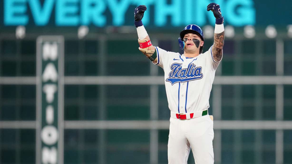 Italy's Andrew Fischer celebrates after hitting a two-run double during the fourth inning of a World Baseball Classic quarterfinal game against Puerto Rico, Saturday, March 14, 2026, in Houston.