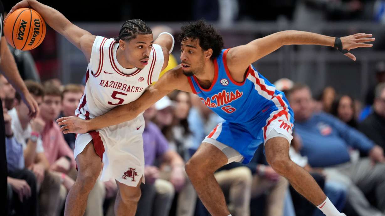 Arkansas guard Darius Acuff Jr. (5) dribbles the ball past Mississippi guard Ilias Kamardine (6) during the first half of an NCAA college basketball game in the semifinals of the Southeastern Conference tournament Saturday, March 14, 2026, in Nashville, Tenn.