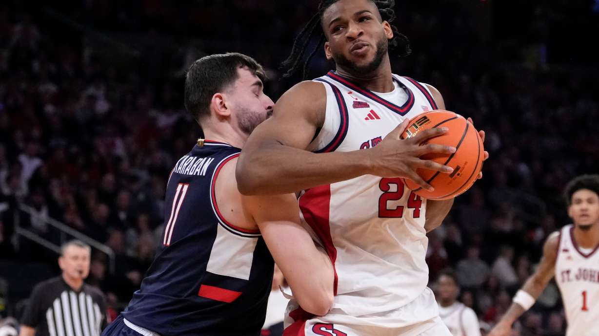 St. John's forward Zuby Ejiofor (24) drives past UConn forward Alex Karaban (11) during the first half of an NCAA college basketball game in the championship of the Big East tournament, Saturday, March 14, 2026, in New York.