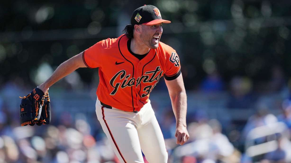 San Francisco Giants starting pitcher Robbie Ray follows through with his pitch delivery during the first inning of a spring training baseball game against the Los Angeles Dodgers Friday, Feb. 27, 2026, in Scottsdale, Ariz.