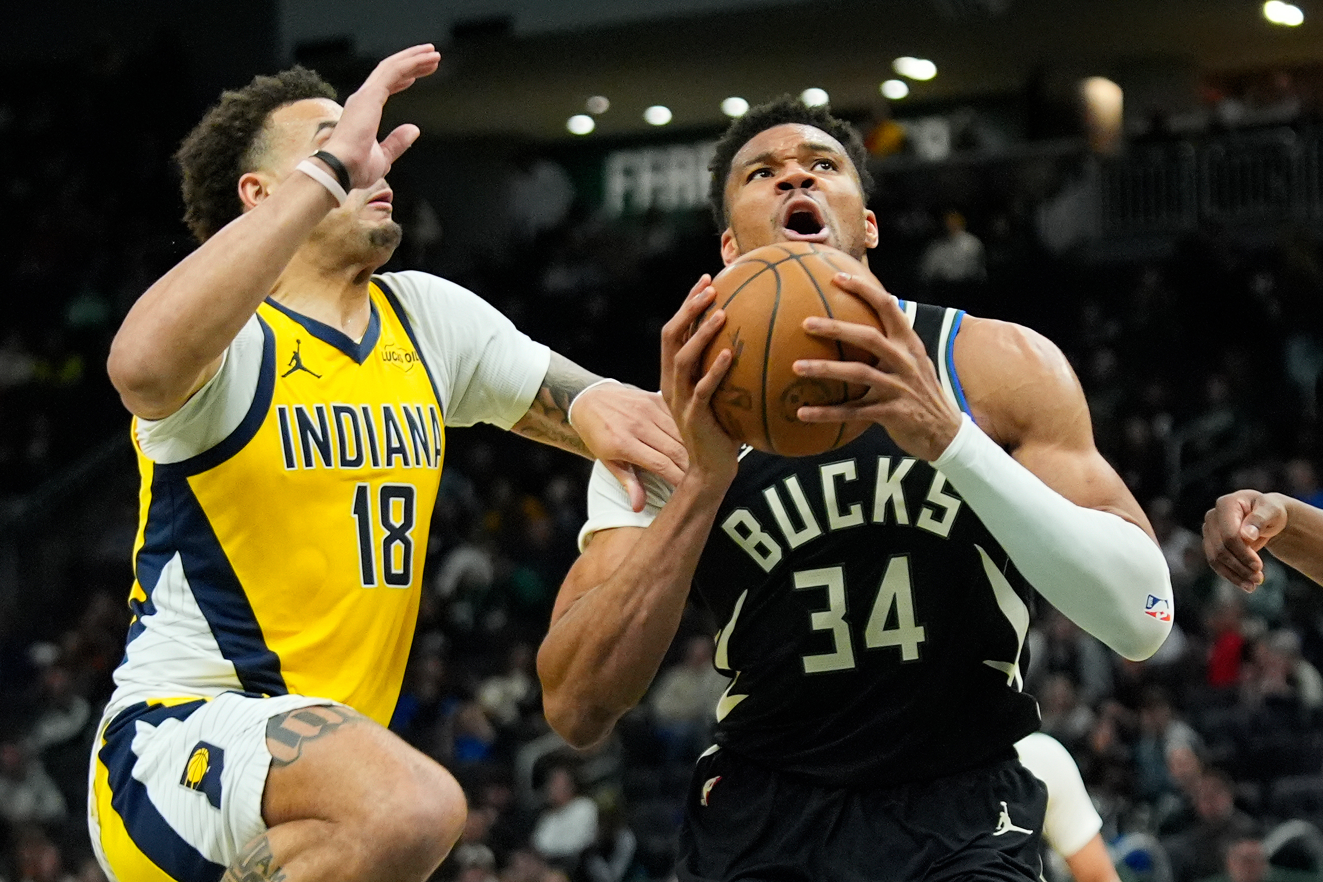 Giannis Antetokounmpo leaves Bucks' victory over Pacers after landing awkwardly on dunk
