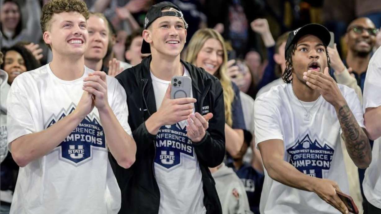 Utah State guard Mason Falslev, left, guard Drake Allen, and guard MJ Collins Jr. celebrate after it was announced they will play Villanova in the NCAA Tournament on Friday in the first round.
