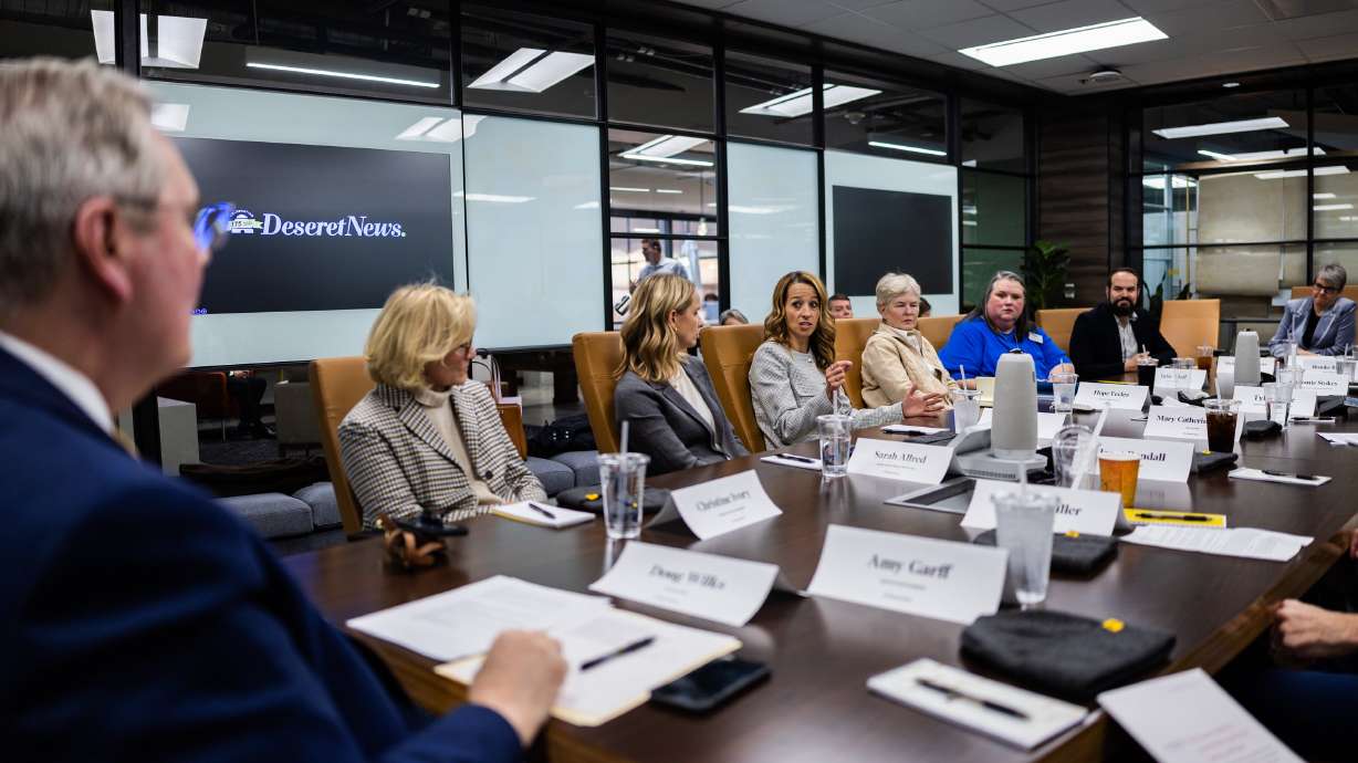 Doug Wilks, executive editor of the Deseret News, left, listens as Utah first lady Abby Cox speaks during a Deseret News editorial roundtable discussing education in Utah at the Triad Center in Salt Lake City on Jan. 8.