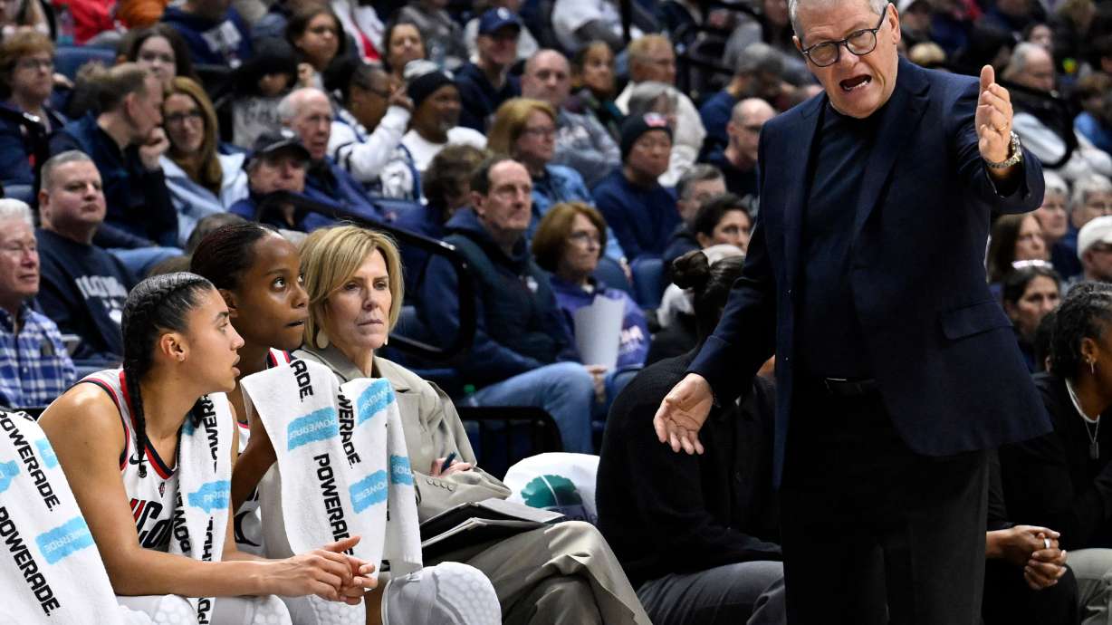 UConn head coach Geno Auriemma, right, speaks as UConn guards Azzi Fudd, left, Blanca Quinonez, second from left, and associate head coach Chris Dailey, third from left, listen in the second half of an NCAA college basketball game against Providence, Sunday, Feb. 22, 2026, in Storrs, Conn.