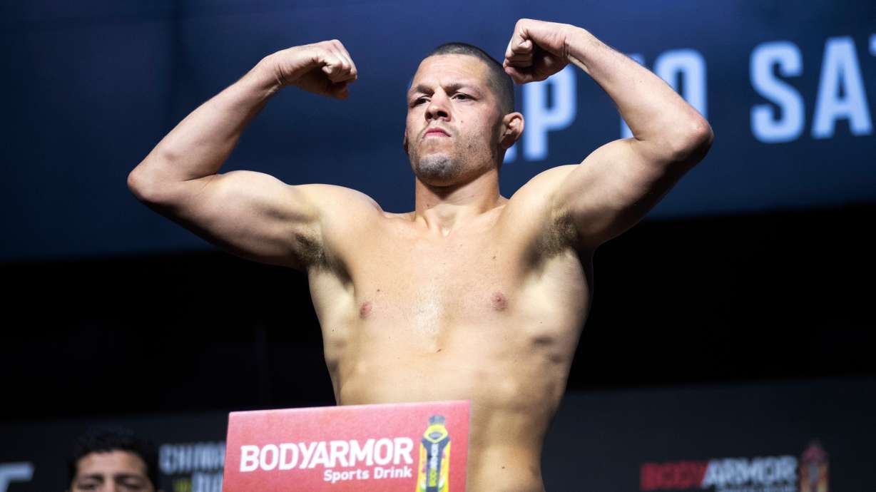 FILE - Nate Diaz poses on the scale during a ceremonial weigh-in for the UFC 279 mixed martial arts event on Sept. 9, 2022, in Las Vegas.