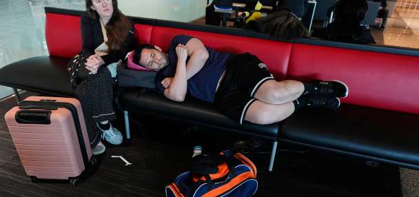 Flight cancellations and delays continue after storms dump snow in the Midwest and head east