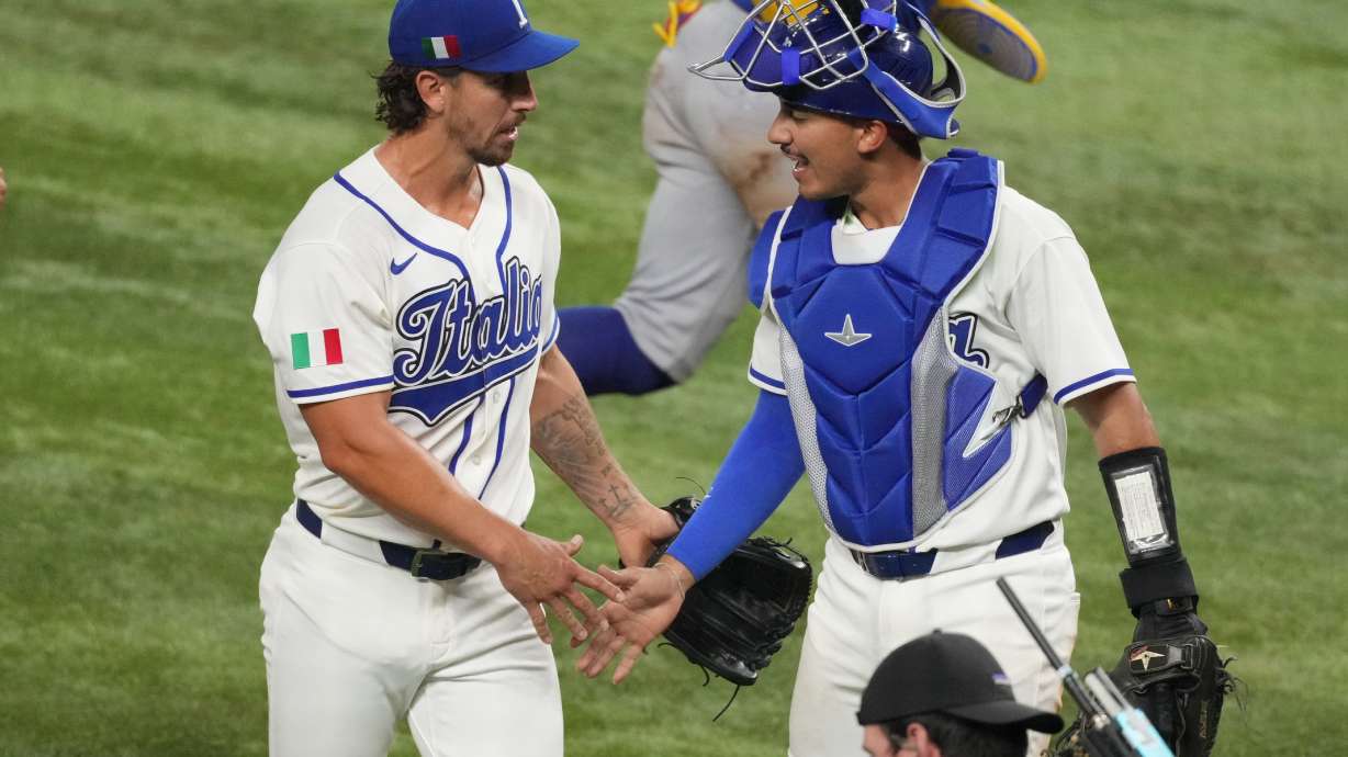 Italy pitcher Michael Lorenzen and catcher JJ D'Orazio shake hands during the fifth inning of a World Baseball Classic semifinal game against Venezuela, Monday, March 16, 2026, in Miami.