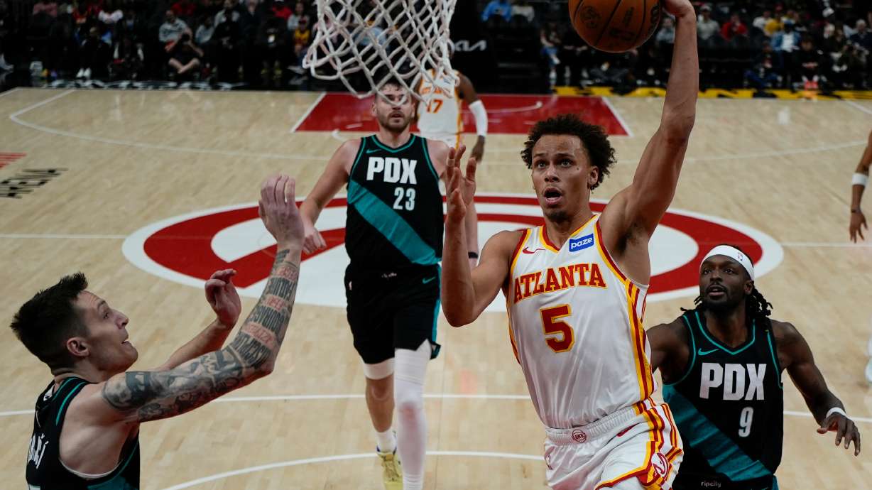 Atlanta Hawks guard Dyson Daniels (5) shoots against Portland Trail Blazers guard Vit Krejci (27) during the first half of an NBA basketball game, Sunday, March 1, 2026, in Atlanta.