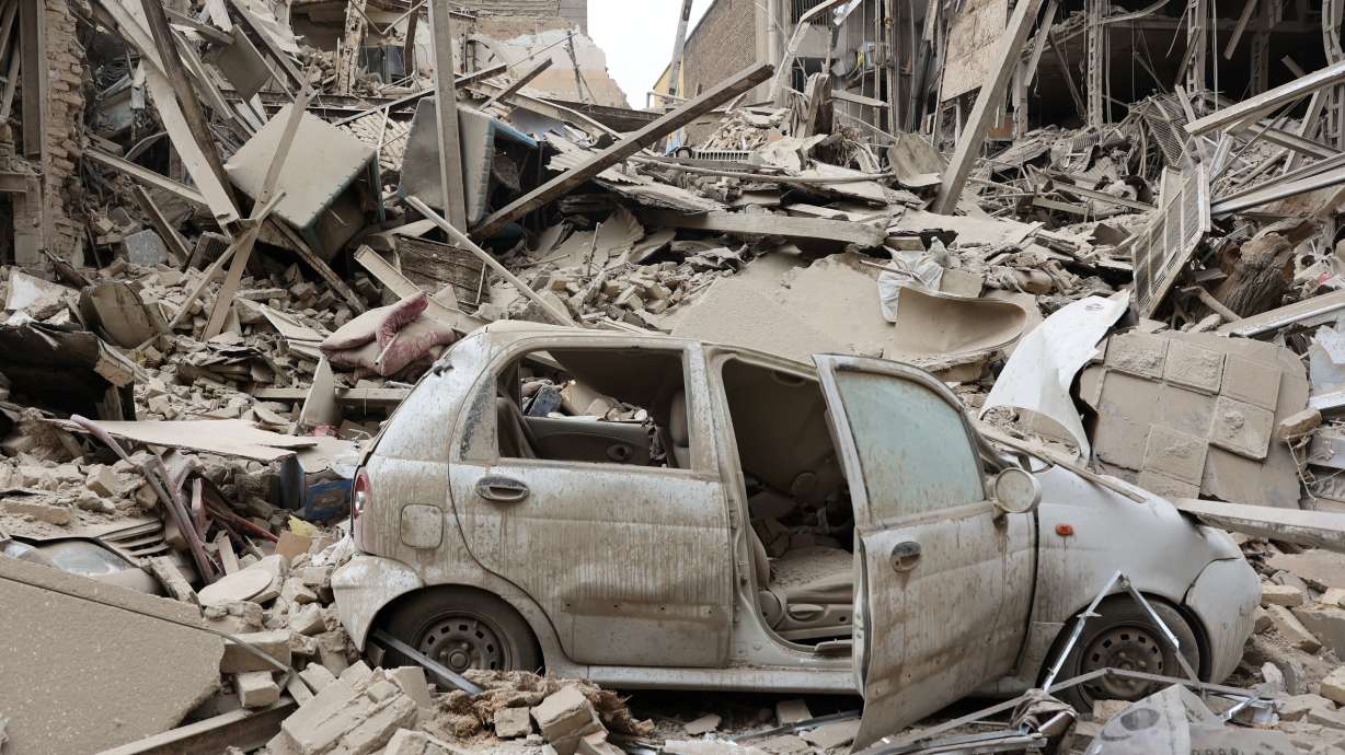 A destroyed vehicle amid rubble at the site of a strike on a residential building, amid the U.S.-Israeli conflict with Iran, in Tehran, Iran, Monday.