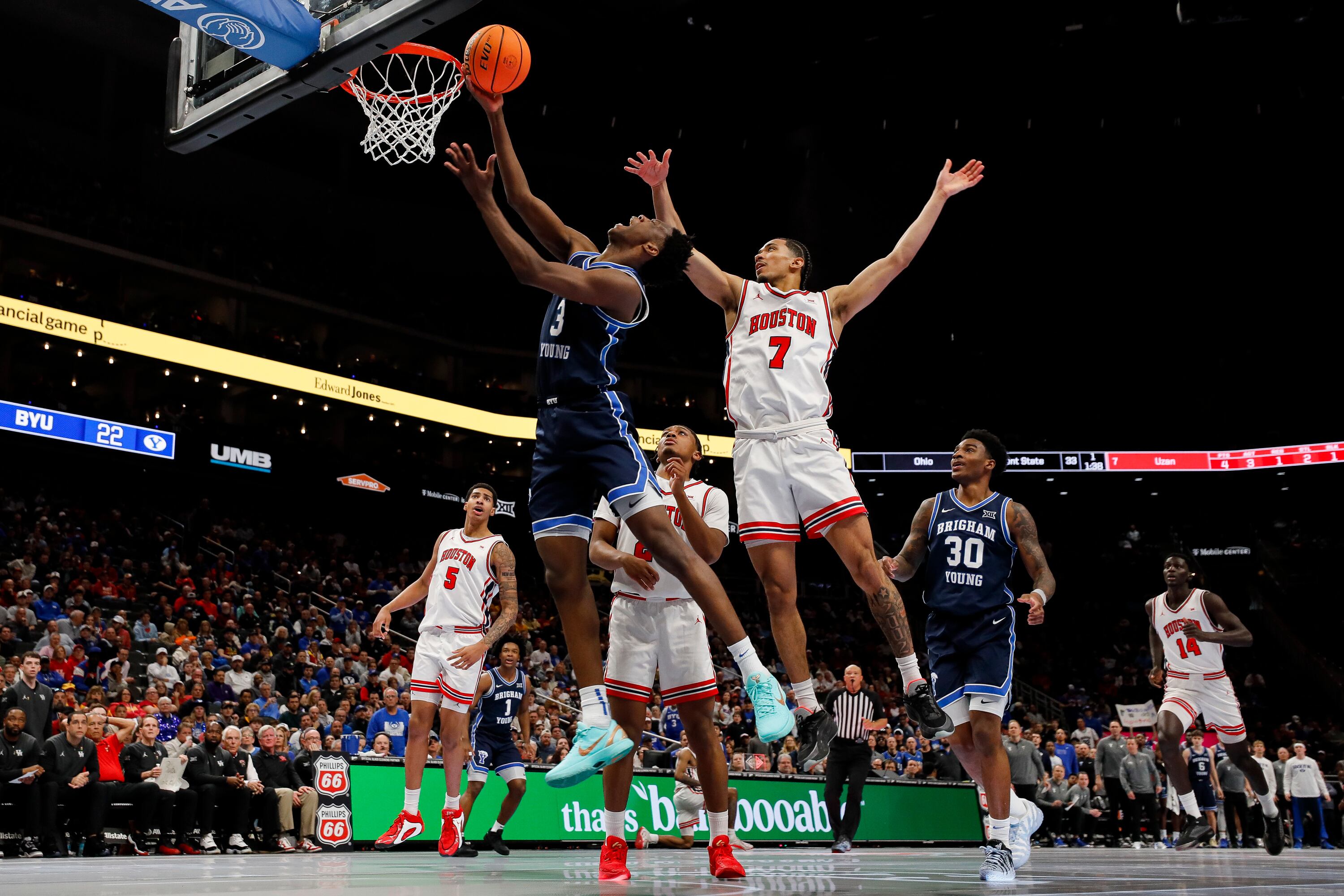 BYU forward AJ Dybantsa (3) drives to the basket for a layup against Houston Cougars guard Milos Uzan (7) during the first half of the the quarterfinal of the 2026 Phillips 66 Big 12 Men's Basketball Tournament at the T-Mobile Center in Kansas City, Missouri, on Thursday.