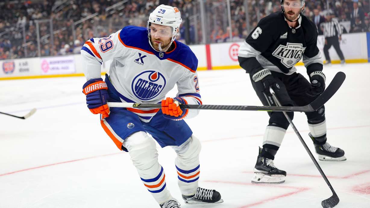 Edmonton Oilers center Leon Draisaitl, left, skates against Los Angeles Kings defenseman Joel Edmundson during the first period of an NHL hockey game Thursday, Feb. 26, 2026 in Los Angeles.