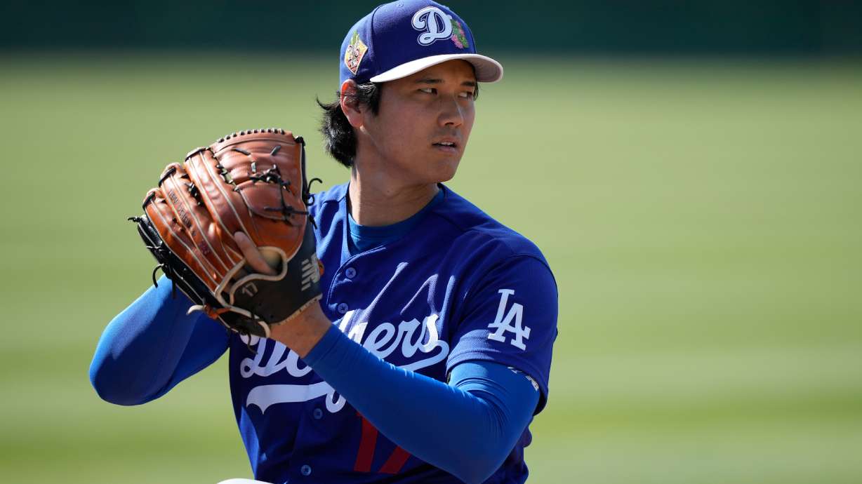 Los Angeles Dodgers two-way player Shohei Ohtani (17) warms up during spring training baseball on Sunday, Feb. 22, 2026, in Phoenix.