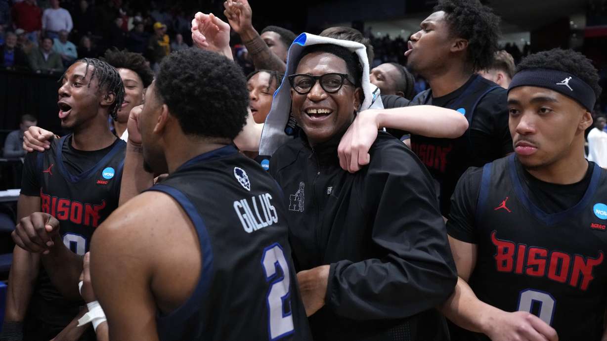 Howard head coach Kenneth Blakeney, center, and Howard players celebrate at the conclusion of the second half in a First Four college basketball game in the NCAA Tournament against UMBC, Tuesday, March 17, 2026, in Dayton, Ohio.