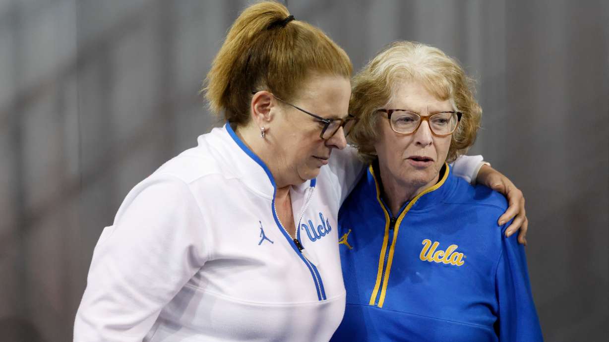 UCLA head coach Cori Close, left, embraces her mother, Patti Close, after speaking with the media after an NCAA college basketball game against Rutgers, Wednesday, Feb. 4, 2026, in Los Angeles.