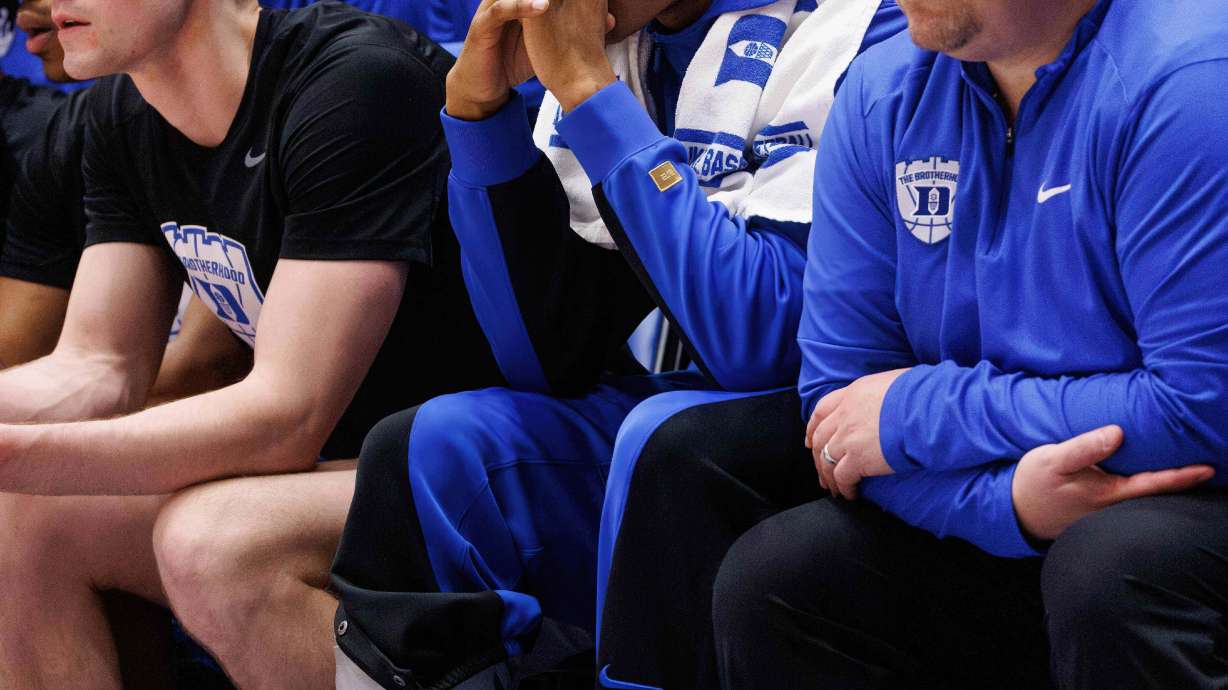 Duke's Caleb Foster sits on the bench wearing a boot after suffering an injury during the first half of an NCAA college basketball game against North Carolina in Durham, N.C., Saturday, March 7, 2026.