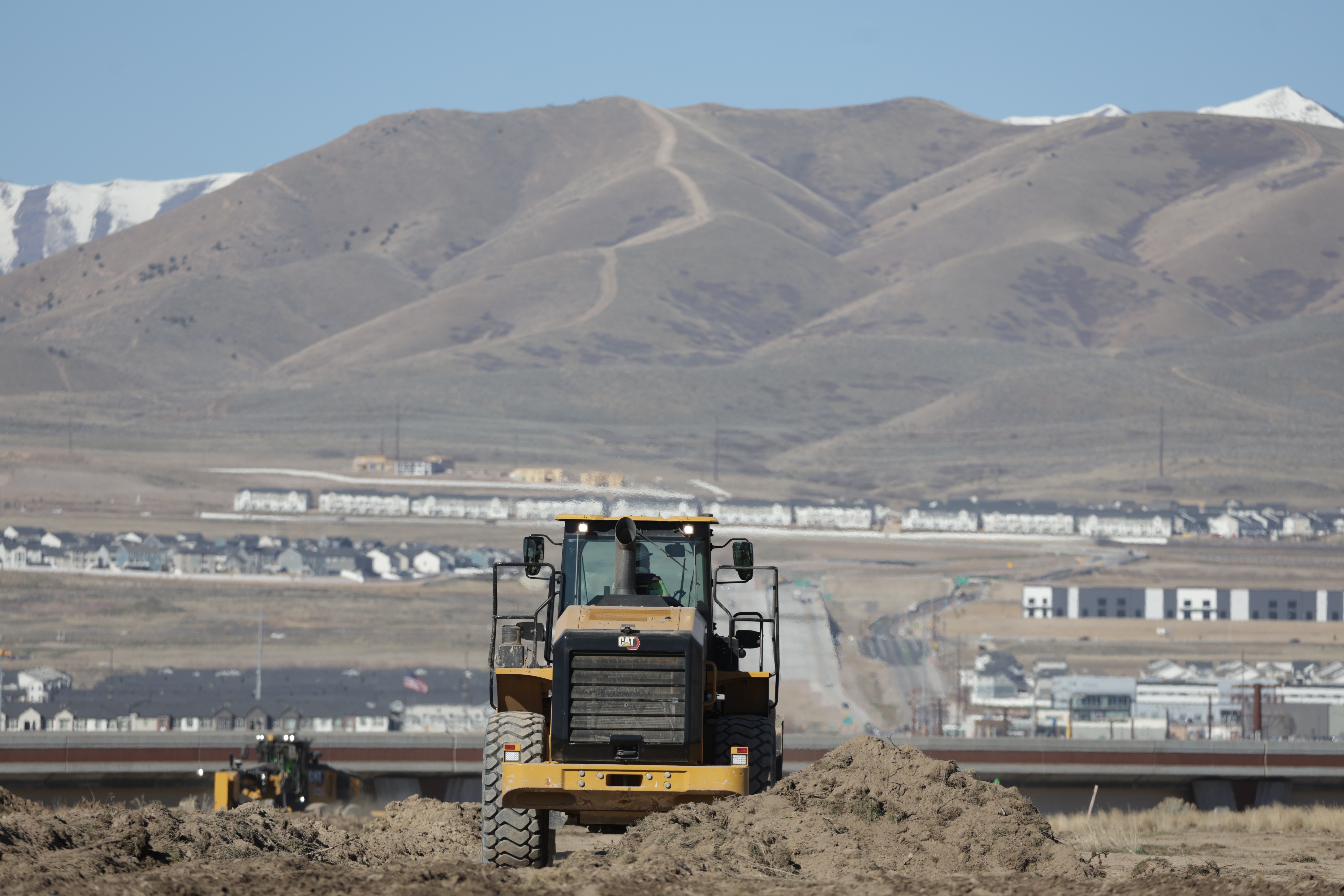 Construction workers begin working on the 2100 North freeway after Utah Department of Transportation officials broke ground for the project in Lehi on Wednesday.