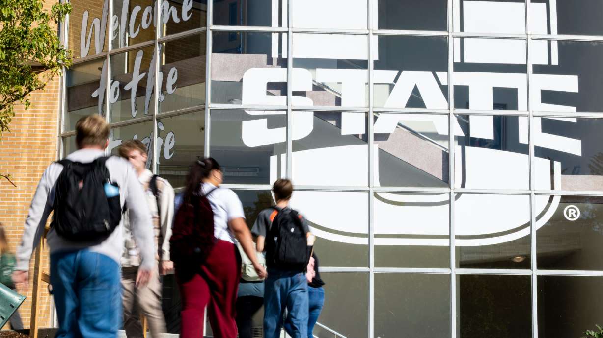 Students walk to and from the Glen L. Taggart Student Center on the campus of Utah State University in Logan on Oct. 1. Utah Rep. Burgess Owens is proposing legislation to help prevent scammers from submitting applications for federal student aid.