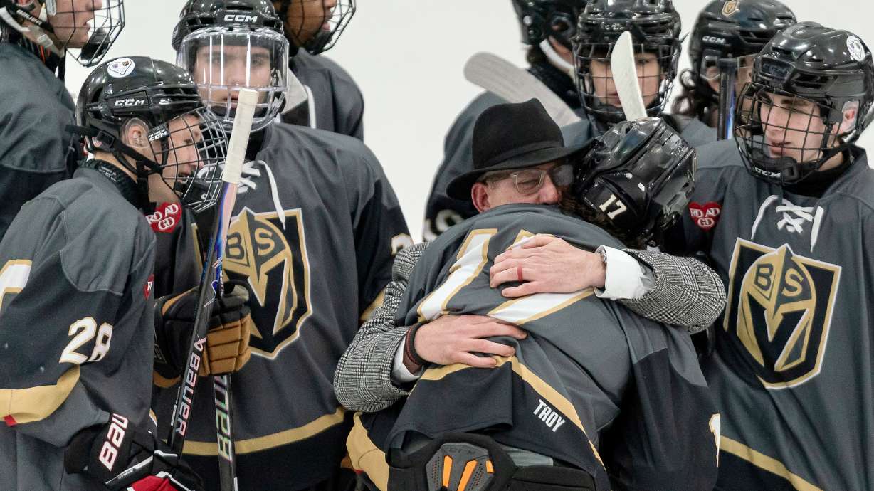 Blackstone Valley Schools head coach Chris Librizzi embraces Colin Dorgan after Dorgan scored the double-overtime game-winning goal against Portsmouth High School in the Rhode Island high school hockey state semifinal, Wednesday, March 11, 2026, at Schneider Arena on the campus of Providence College in Providence, R.I.