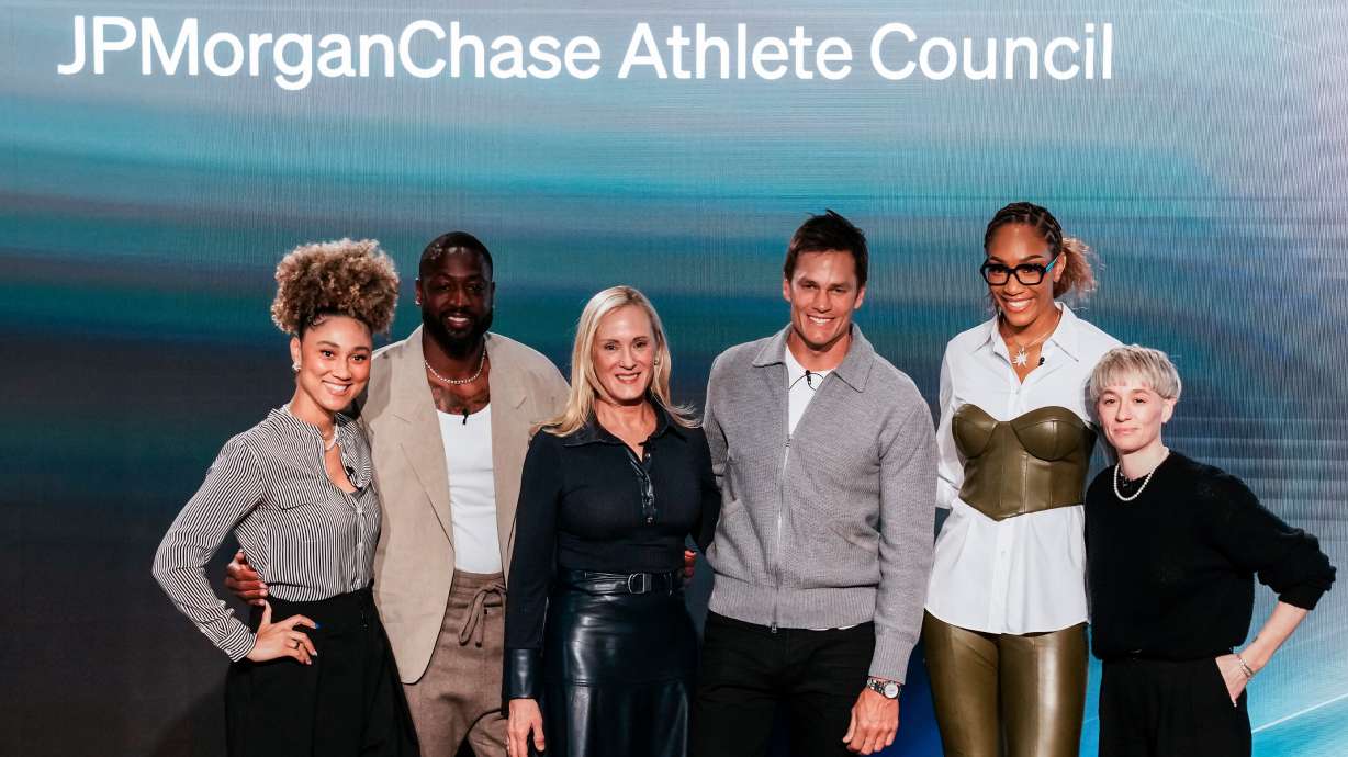 Kristin Lemkau, CEO, J.P. Morgan Wealth Management, center left, poses for a picture with, from left, Ally Love, Peloton Instructor + VP, Instructor Strategy & Development, Dwyane Wade, former NBA basketball player, Tom Brady, former NFL football player, A'ja Wilson WNBA basketblal player, and Meg Rapinoe, former women's soccer player, during a Pro Athlete event at JPMorganChase headquarters in New York, Wednesday, March 18, 2026.