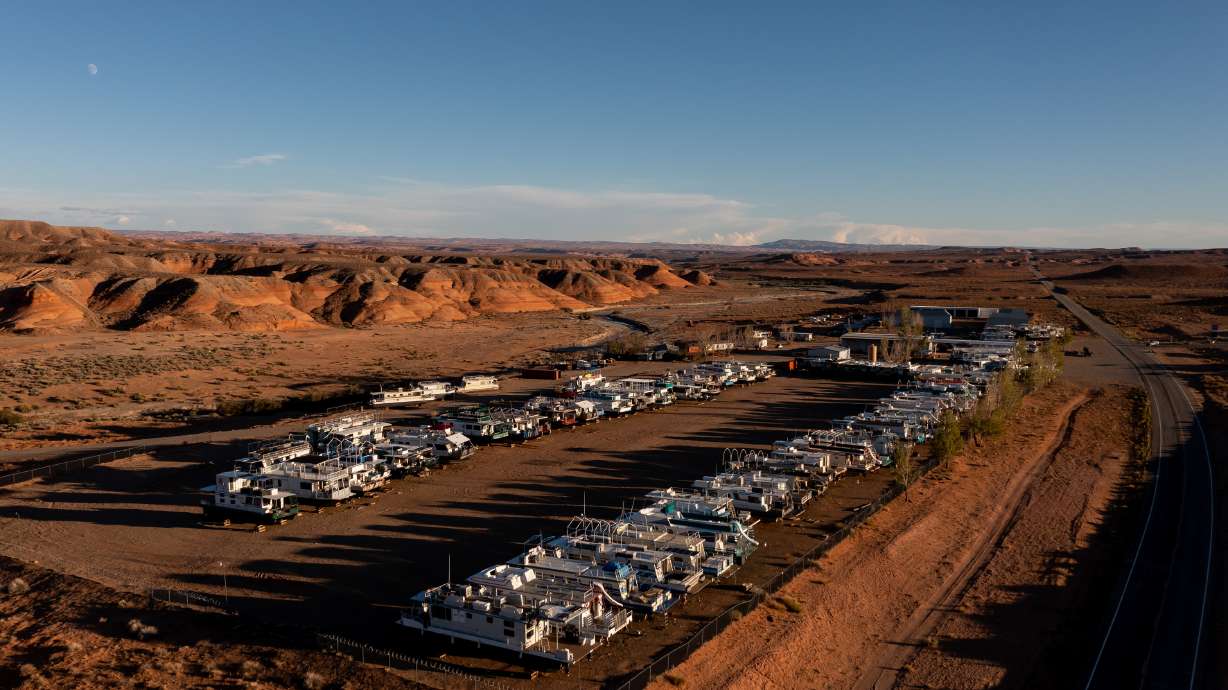 Houseboats are stored several miles from Bullfrog Marina on Lake Powell on Oct. 5, 2022. The marina will be temporarily relocated closer to Halls Crossing Marina in the coming weeks, officials said on Wednesday.