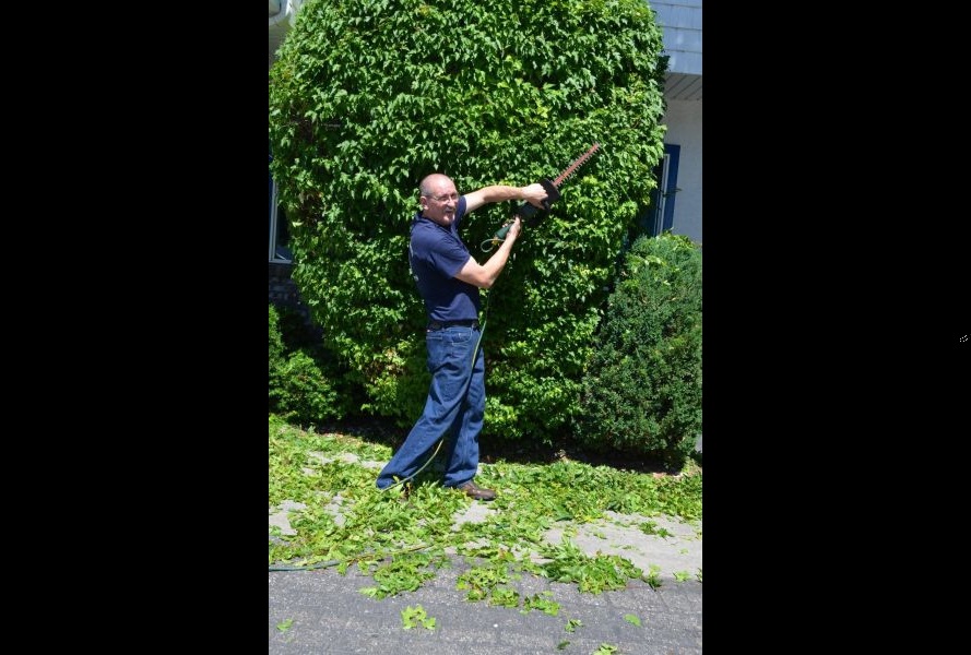 Leo Wallace trimming trees outside Rupe's in Blackfoot, Idaho. Wallace will be retiring on Thursday.