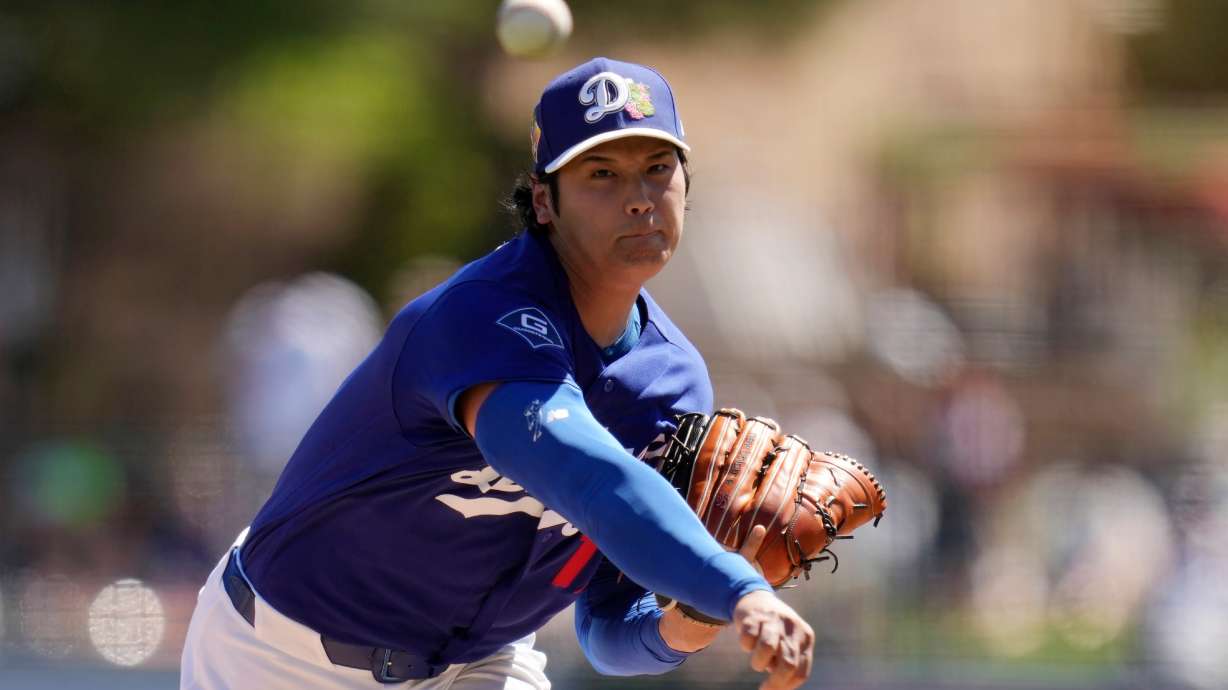 Los Angeles Dodgers starting pitcher Shohei Ohtani, of Japan, throws against the San Francisco Giants during the first inning of a spring training baseball game, Wednesday, March 18, 2026, in Phoenix.