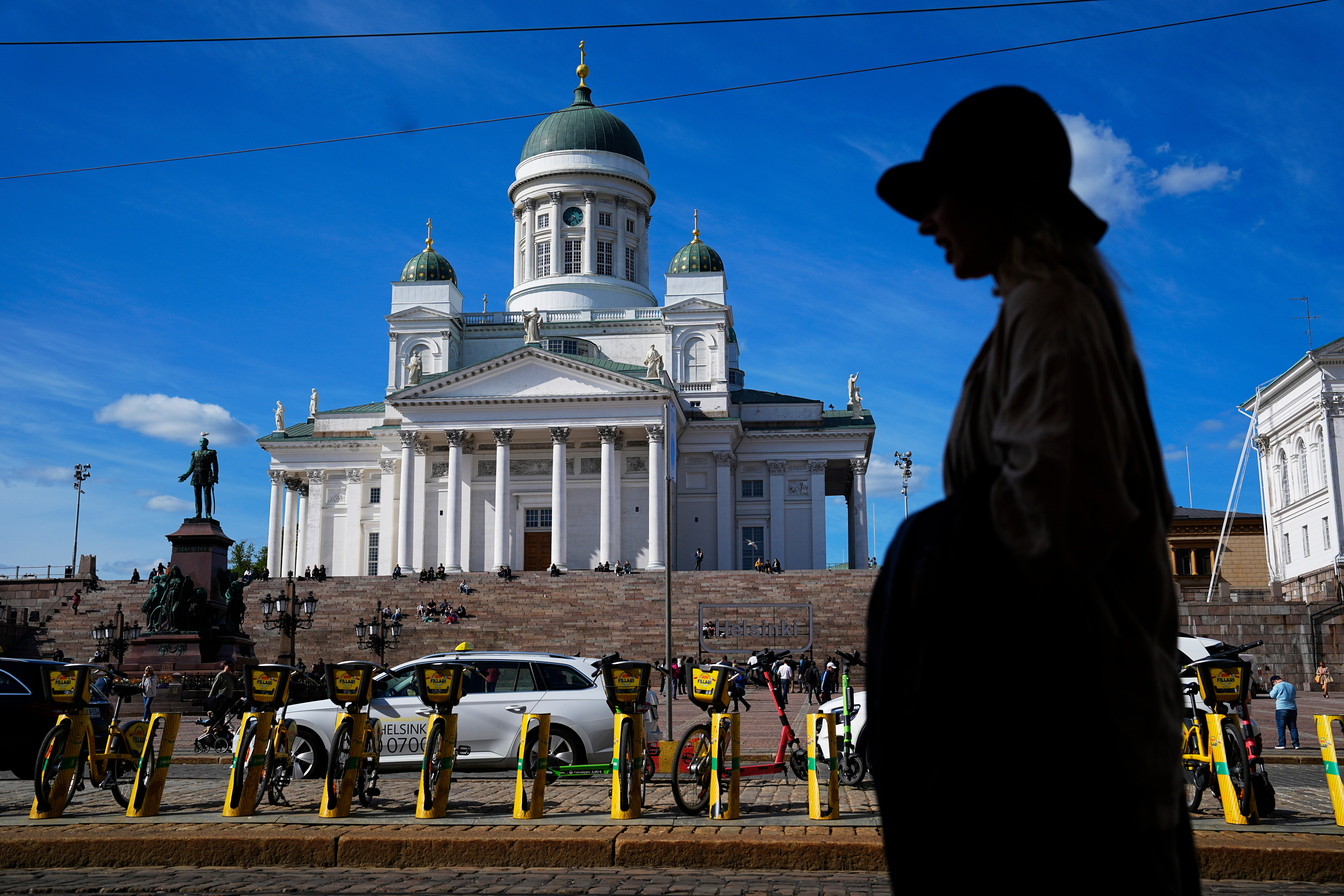 A woman walks past the Helsinki Cathedral in Helsinki, May 29, 2023.