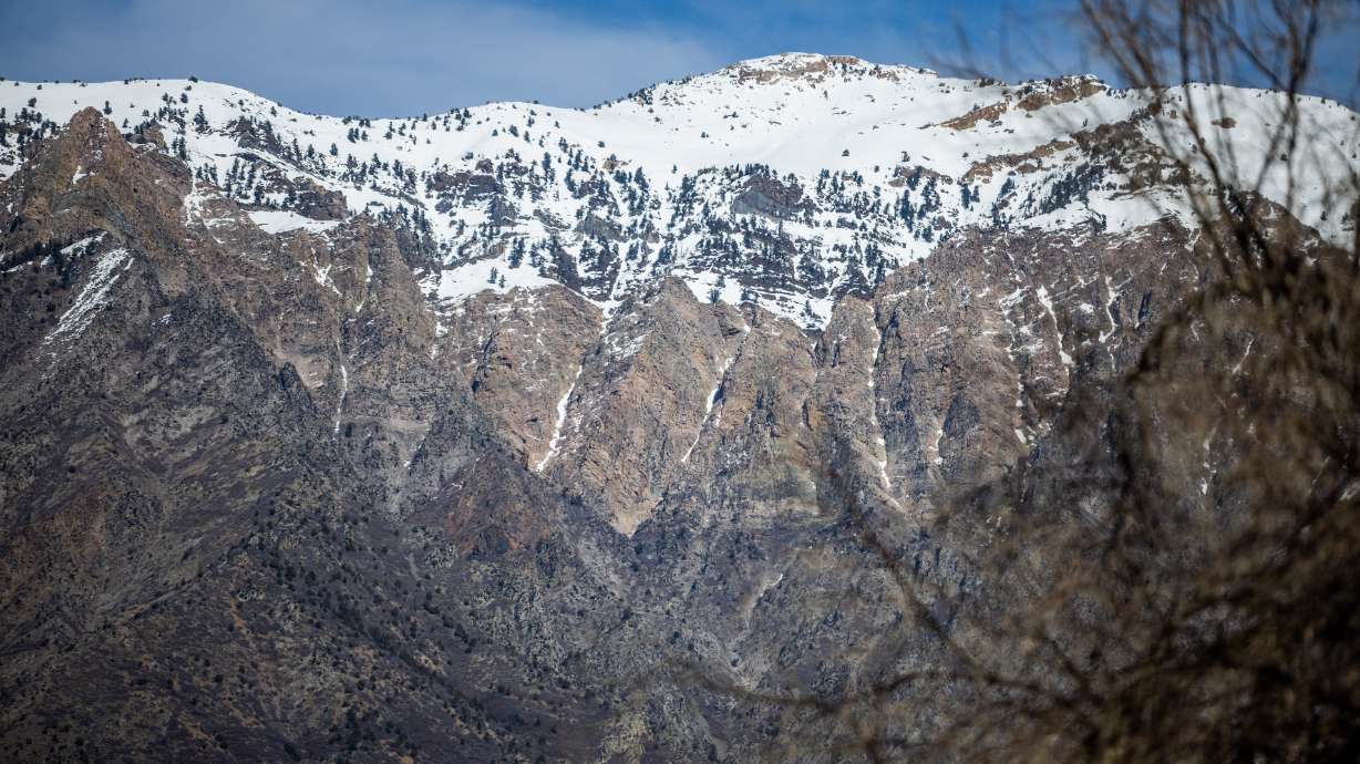 A view of the Wasatch Mountains from Willard Bay State Park in Willard on Tuesday. Warm weather this week has raised the risk of wet avalanches, while more resorts are set to close early.