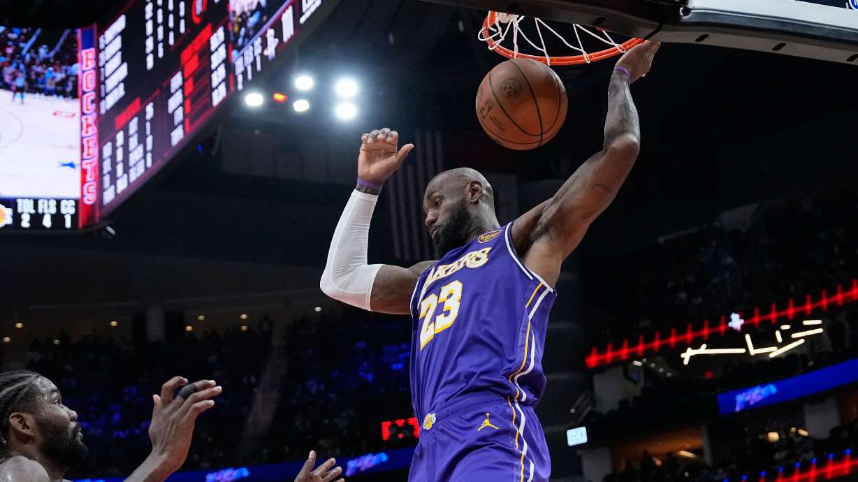 Los Angeles Lakers' LeBron James dunks the ball against the Houston Rockets during the second half of an NBA basketball game Wednesday, March 18, 2026, in Houston.
