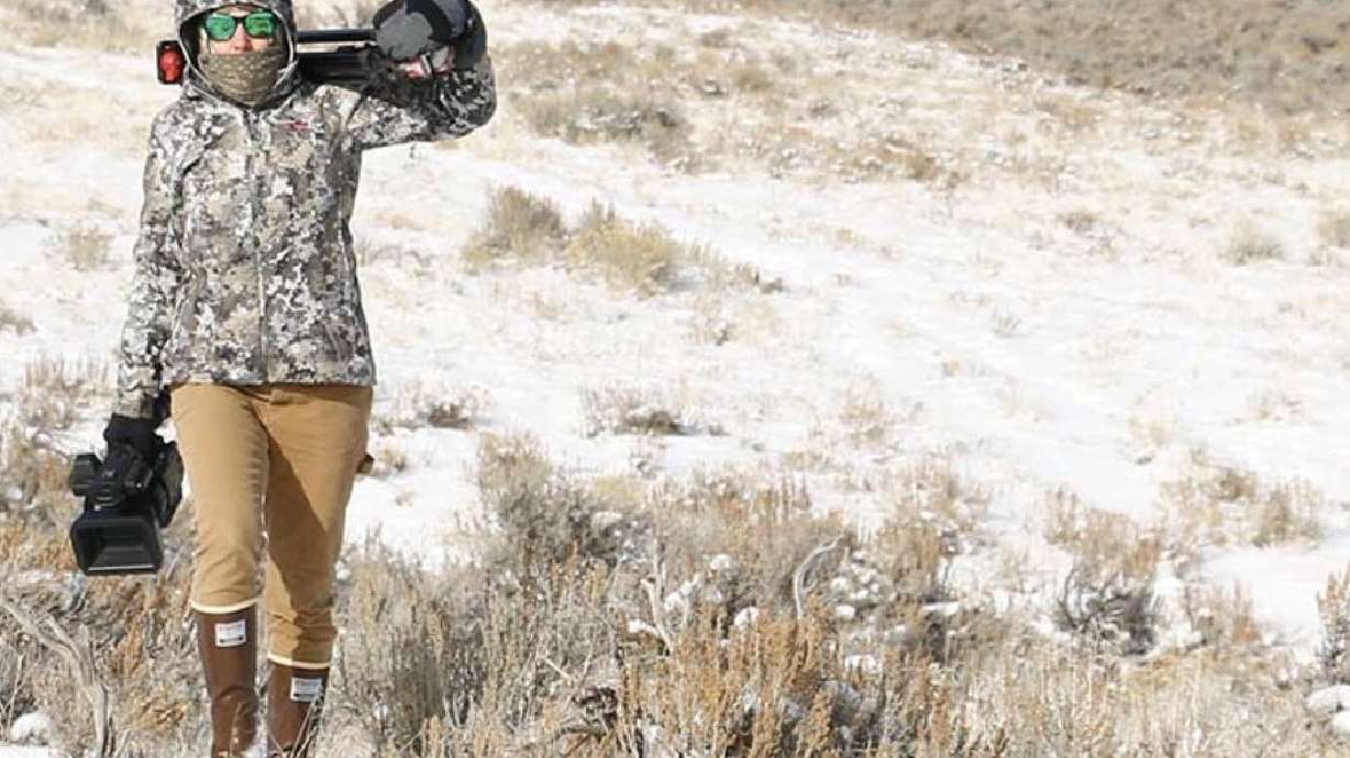 Kris Millgate hauls camera gear on a film shoot. Millgate has been telling stories about Idaho wildlife for two decades, and her latest project is a documentary film about sage grouse.