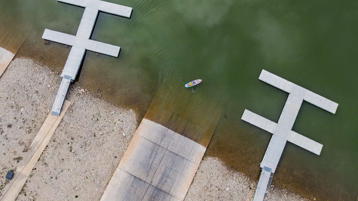 Denis Atkinson prepares to fish off his paddleboard at Willard Bay State Park's South Marina in Willard on Tuesday. Utah water managers are preparing for several impacts this summer.