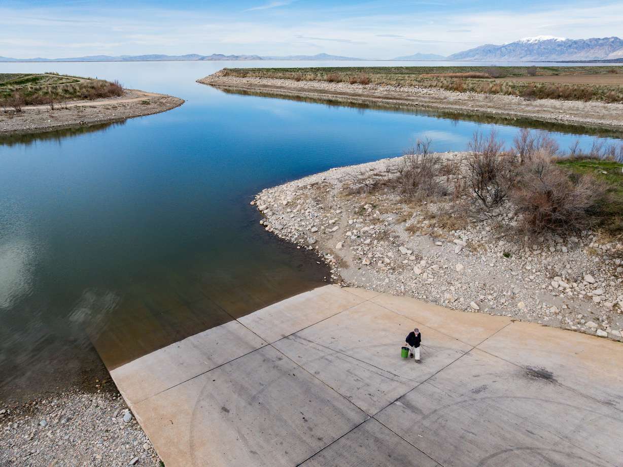 An individual returns to the parking lot after fishing at Willard Bay State Park's South Marina in Willard on Tuesday. Saturated soils may make up for the low snowpack the West is experiencing this year.