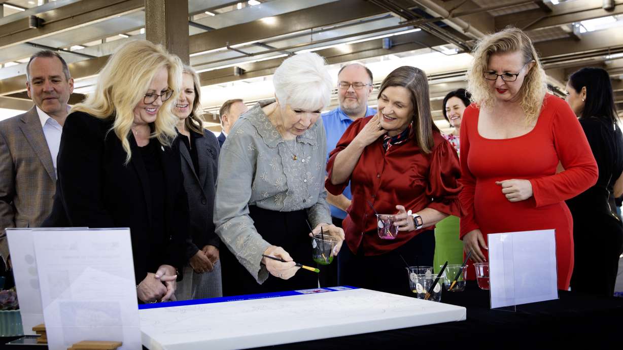 South Jordan Mayor Dawn Ramsey, Gail Miller, Salt Lake City Mayor Jenny Wilson and Salt Lake County Councilwoman Laurie Stringham paint artwork depicting the new Miller Arts Center during a groundbreaking in South Jordan, Thursday.
