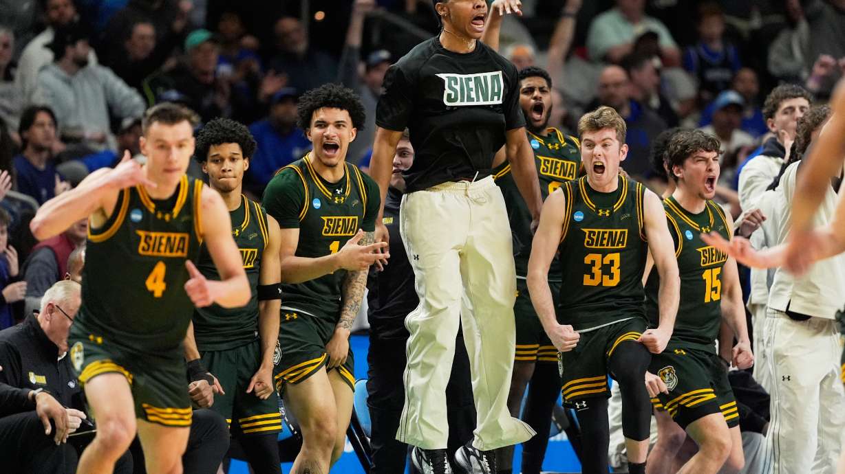Siena celebrates after scoring against Duke during the second half in the first round of the NCAA college basketball tournament, Thursday, March 19, 2026, in Greenville, S.C.