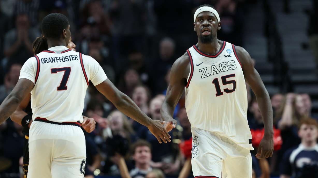 Gonzaga forward Graham Ike (15) reacts with guard Tyon Grant-Foster after a play during the second half in the first round of the NCAA college basketball tournament against Kennesaw State, Thursday, March 19, 2026, in Portland, Ore.