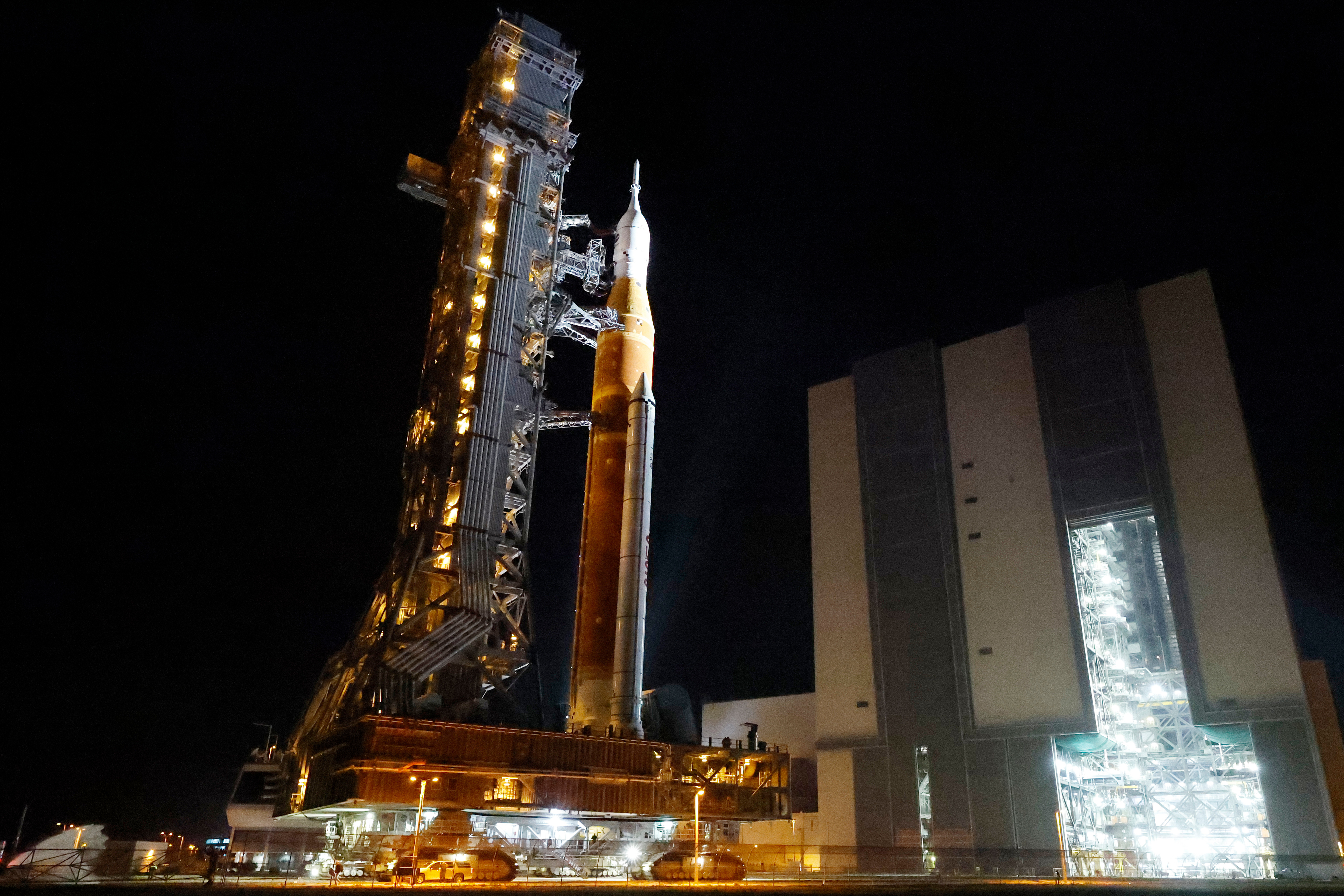 NASA hauls repaired moon rocket from hangar back to pad for early April launch