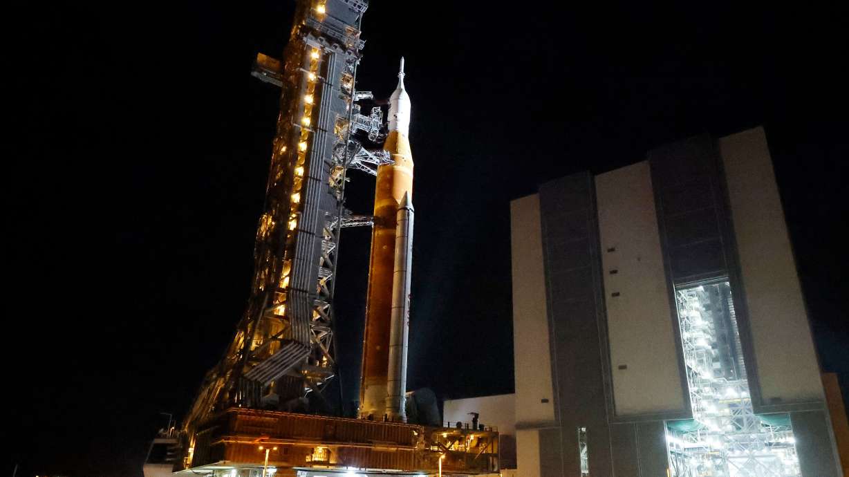 The NASA Artemis II rocket with the Orion spacecraft aboard leaves the Vehicle Assembly Building, moving slowly to pad 39B at the Kennedy Space Center in Cape Canaveral, Fla., on Friday.