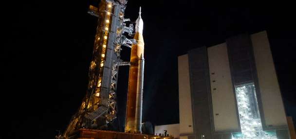 NASA hauls repaired moon rocket from hangar back to pad for early April launch