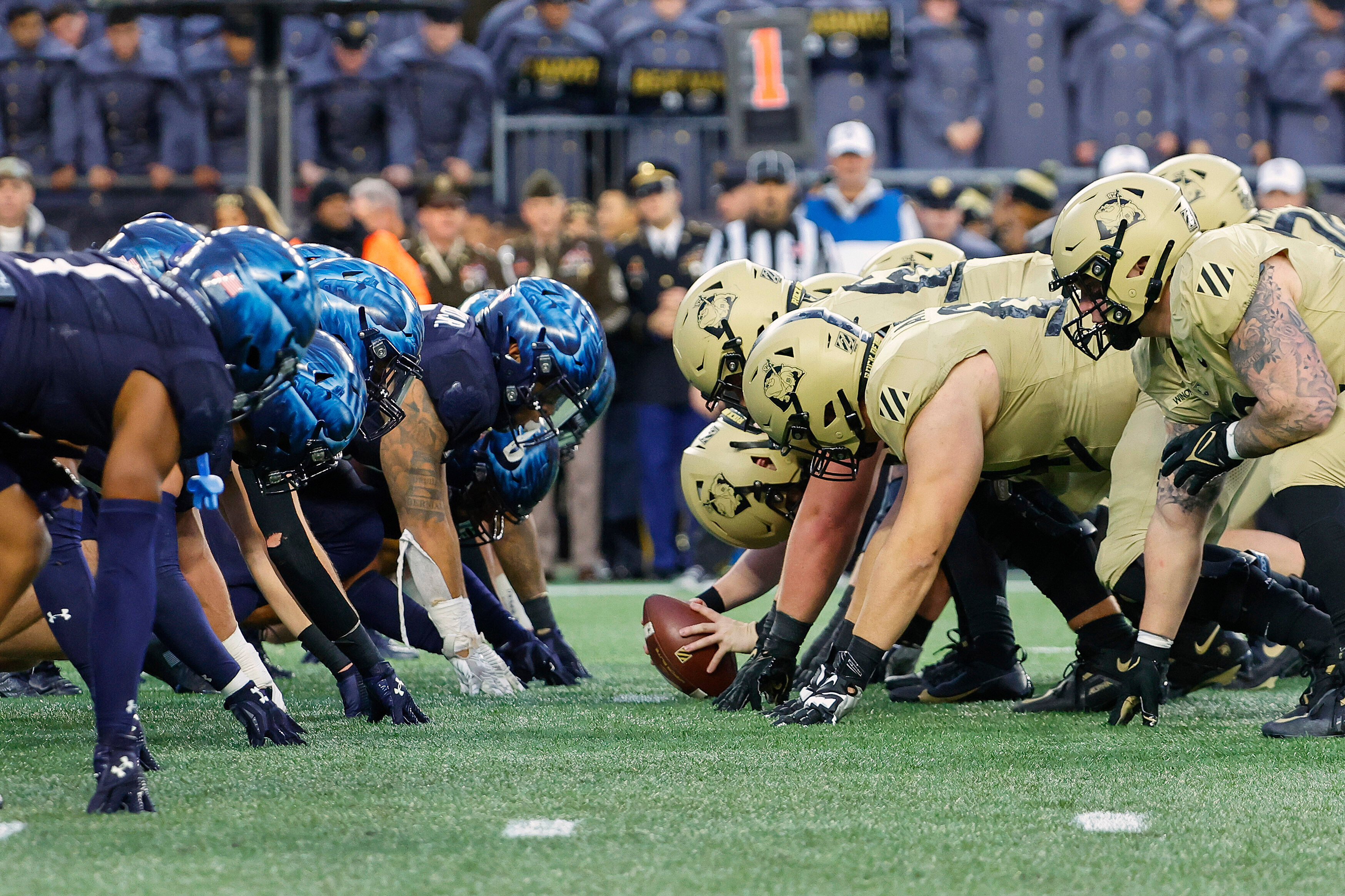 FILE - The Navy, left, and Army line up for the snap at the line of scrimmage during the first quarter of an NCAA football game at Gillette Stadium Saturday, Dec. 9, 2023, in Foxborough, Mass. 