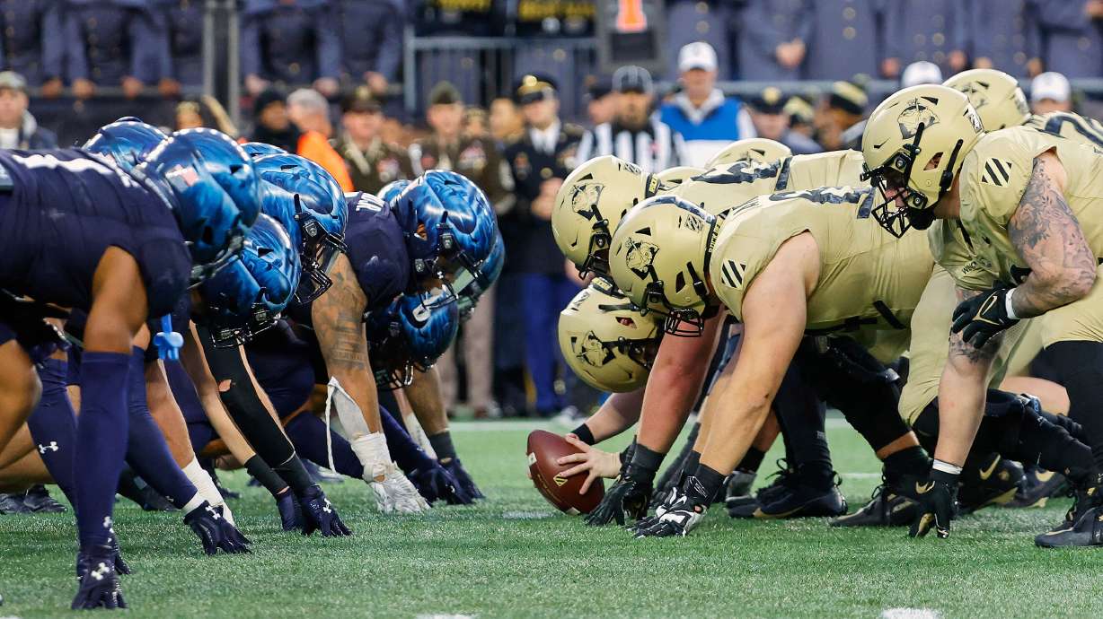 FILE - The Navy, left, and Army line up for the snap at the line of scrimmage during the first quarter of an NCAA football game at Gillette Stadium Saturday, Dec. 9, 2023, in Foxborough, Mass.