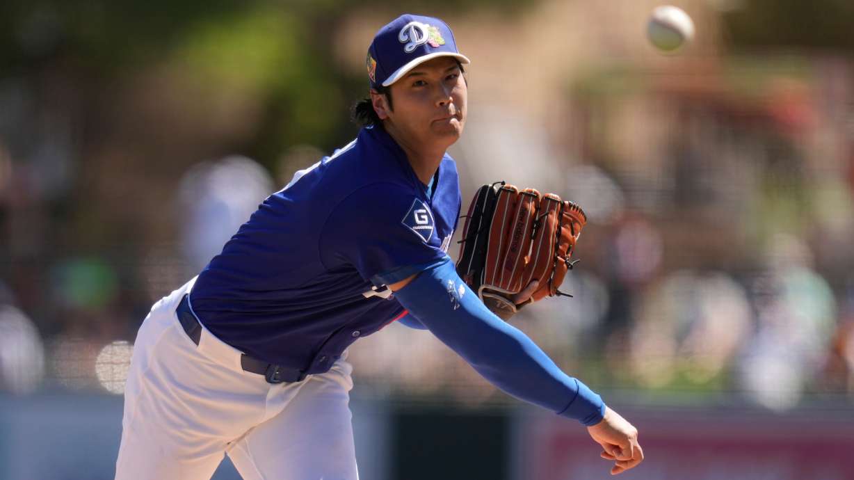 Los Angeles Dodgers starting pitcher Shohei Ohtani, of Japan, throws against the San Francisco Giants during the first inning of a spring training baseball game, Wednesday, March 18, 2026, in Phoenix.