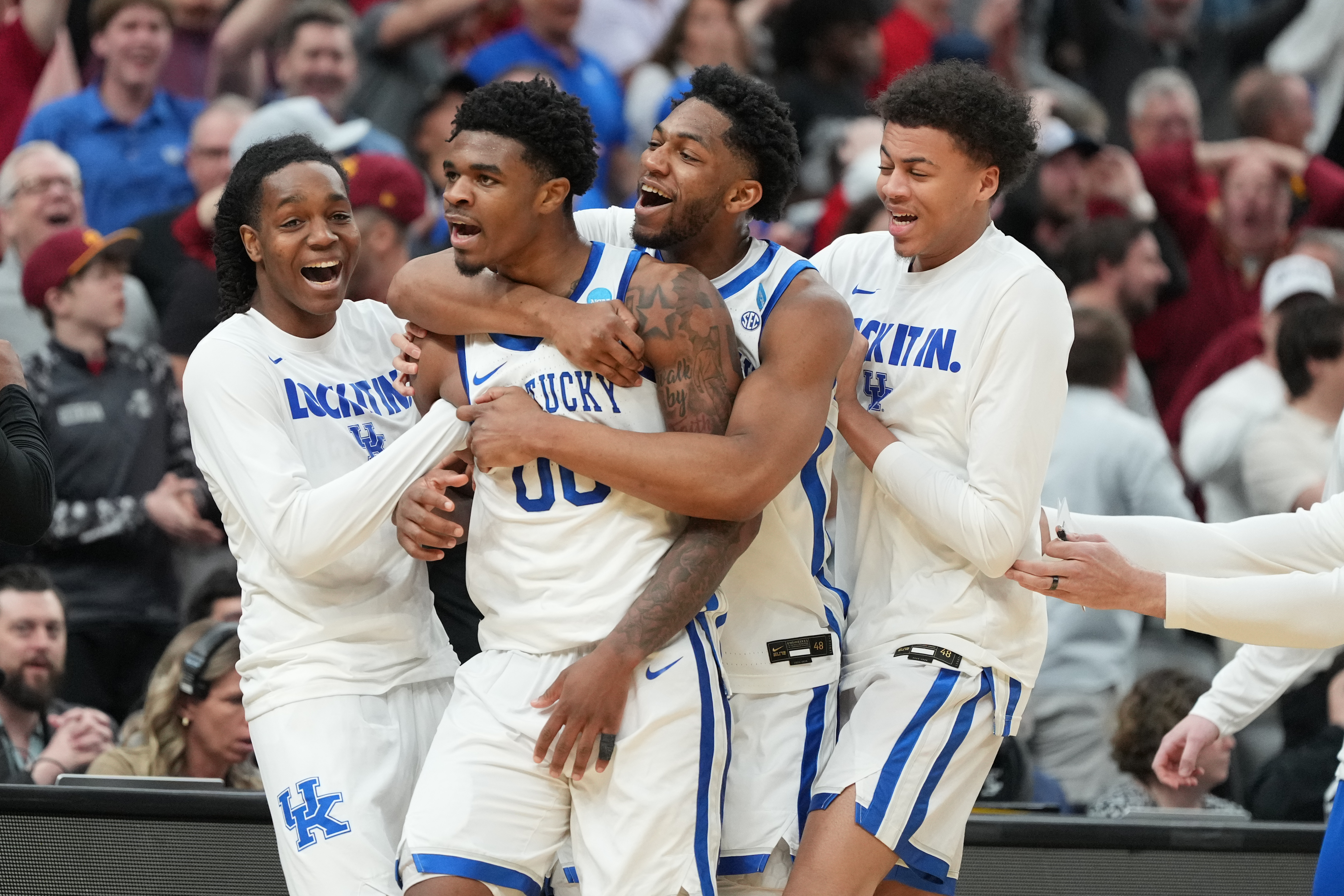 Kentucky's Otega Oweh (00) is congratulated by teammates after sinking a basket at the end of regulation to send the game into overtime in the first round of the NCAA college basketball tournament against Santa Clara, Friday, March 20, 2026, in St. Louis. 