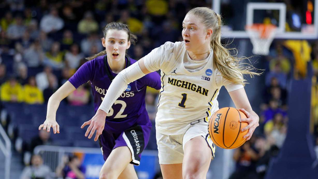 Michigan guard Olivia Olson, right, drives against Holy Cross guard Kendall Eddy, left, during the first half in the first round of the NCAA college basketball tournament Friday, March 20, 2026, in Ann Arbor, Mich.