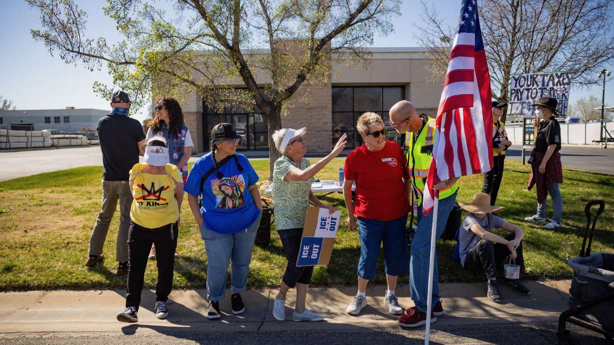 People protest what they say are U.S. Immigration and Customs Enforcement's violations of the city conditional use permit letting it operate at an office in Ogden on Friday. City officials say they've identified no violations.